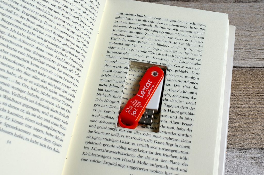 An open book with a red USB key